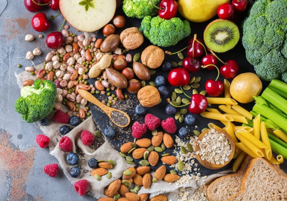 Healthy balanced dieting concept. Selection of rich fiber sources vegan food. Vegetables fruit seeds beans ingredients for cooking. Top view flat lay